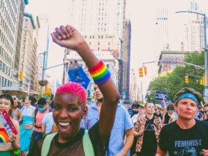 woman raising her fist in support of PRIDE and LGBTQ+ rights